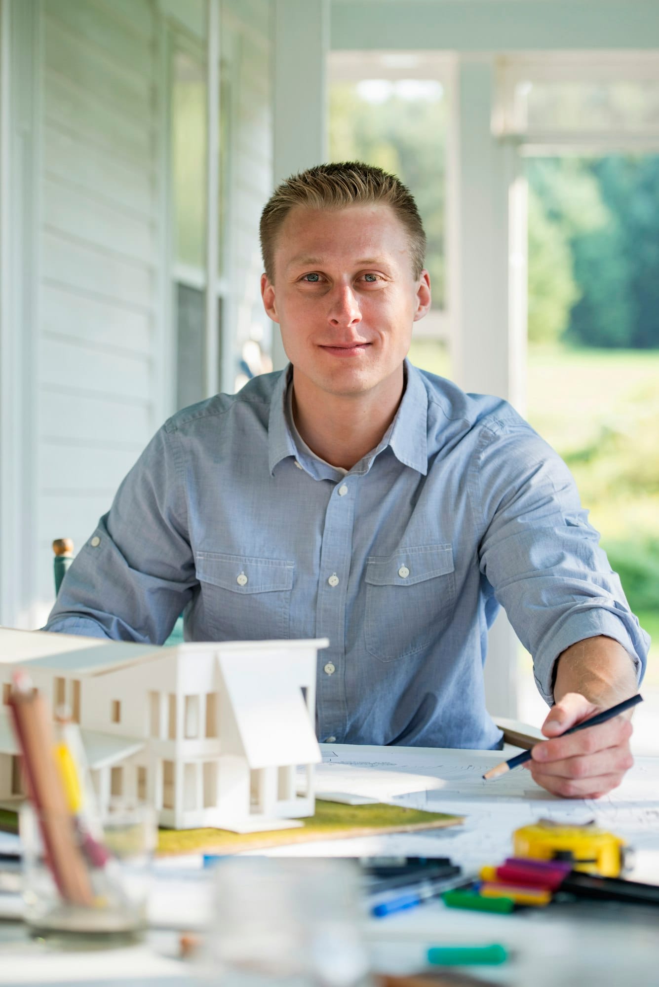 A farmhouse kitchen. A model of a house on the table. Designing a house.